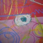 Colourful crayon and chalk scribbles on a red and pink surface with swirls, lines, and a central teal and white oval shape.