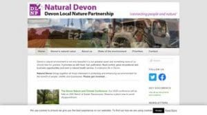 Screenshot of the Natural Devon website homepage, showing navigation menus, a banner image, and information about Devon's natural environment and initiatives.
