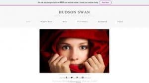 A person wraps a red cloth around their head, with only their face visible, looking directly at the camera on a minimalist photography website.