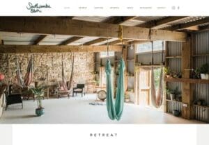 Spacious indoor retreat area with wooden beams, hanging hammocks, potted plants, and natural light from large windows and open doors.